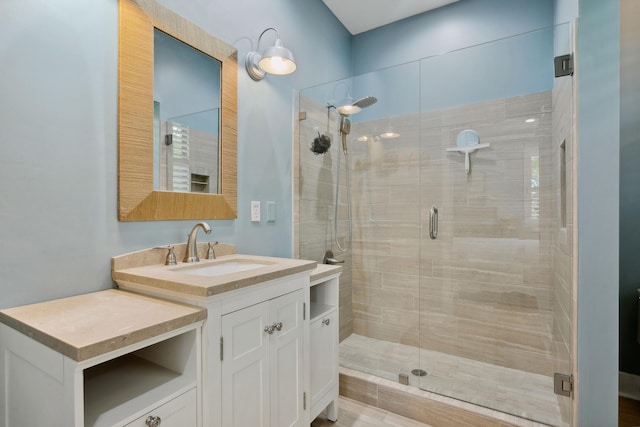 bathroom featuring an enclosed shower and vanity