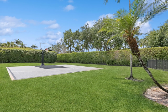 view of basketball court featuring a yard