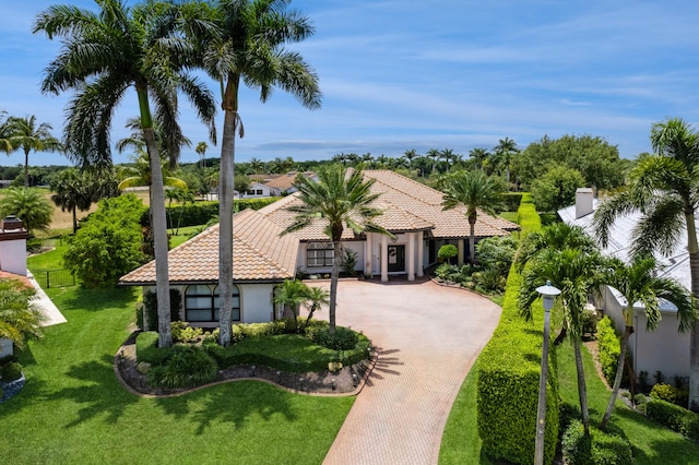 mediterranean / spanish home with a front yard