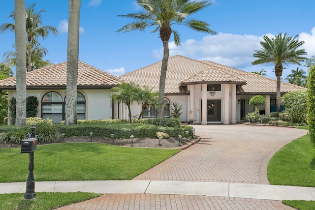 mediterranean / spanish house featuring a front yard