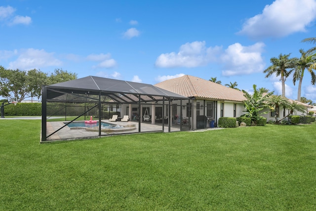 back of house with a patio, a lanai, and a lawn