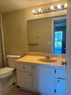 bathroom with vanity, toilet, and an enclosed shower