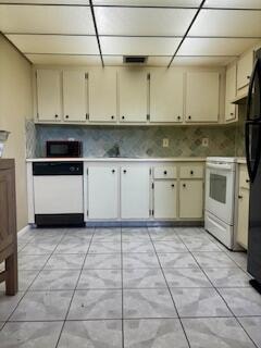 kitchen with decorative backsplash, cream cabinets, and black appliances