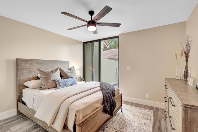 bedroom with ceiling fan and light hardwood / wood-style floors