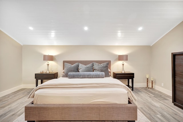 bedroom with light hardwood / wood-style floors and crown molding