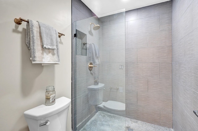 bathroom with tiled shower and toilet