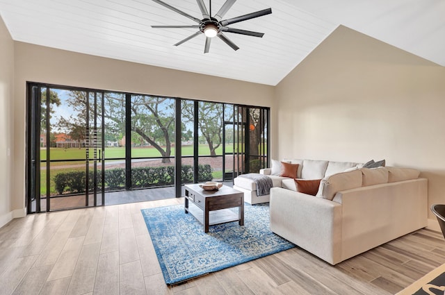 living room with ceiling fan, a healthy amount of sunlight, wooden ceiling, and vaulted ceiling