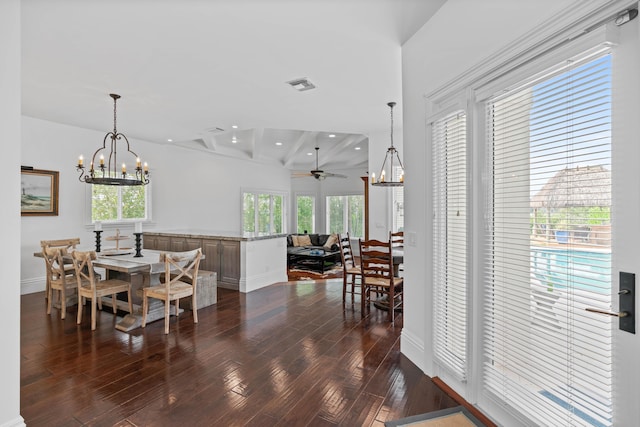 dining room featuring beam ceiling, dark hardwood / wood-style floors, and ceiling fan with notable chandelier