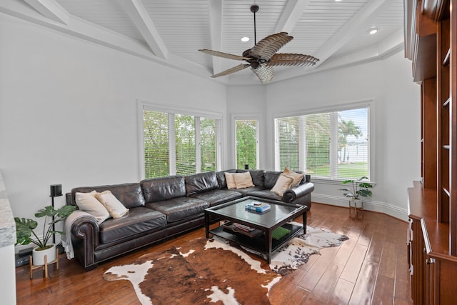 living room with beamed ceiling, wood-type flooring, and ceiling fan