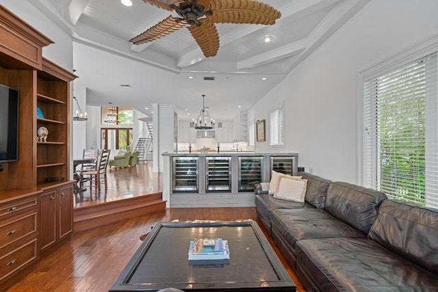 unfurnished living room with beamed ceiling, ceiling fan with notable chandelier, dark hardwood / wood-style floors, and wine cooler