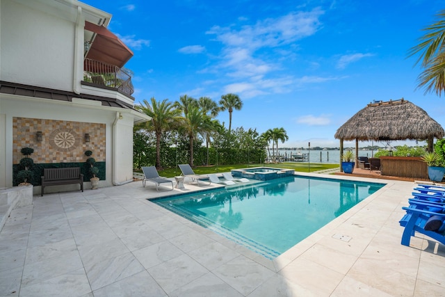 view of swimming pool with a gazebo, a patio area, an in ground hot tub, and a water view