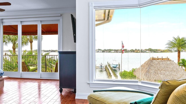 doorway to outside featuring wood-type flooring and ornamental molding