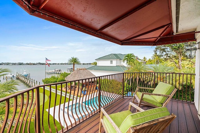 deck featuring a water view and a lawn