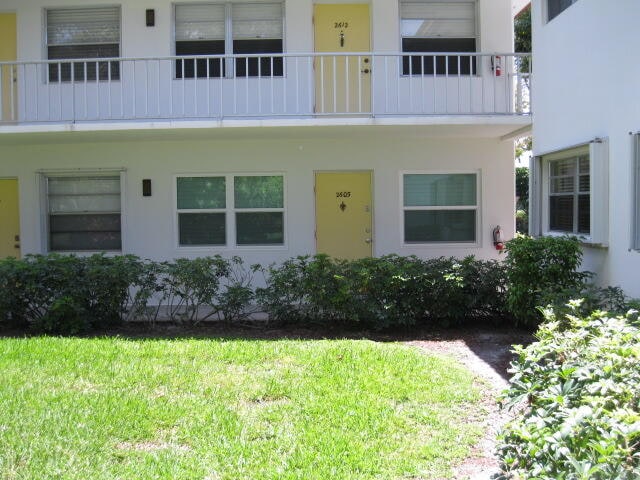 exterior space featuring a yard and a balcony