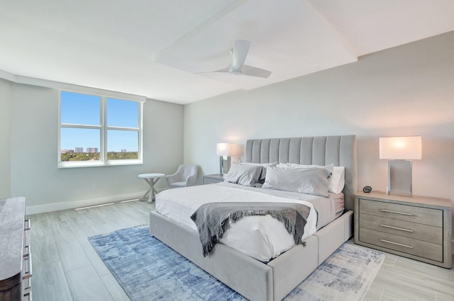 bedroom with ceiling fan and light hardwood / wood-style flooring