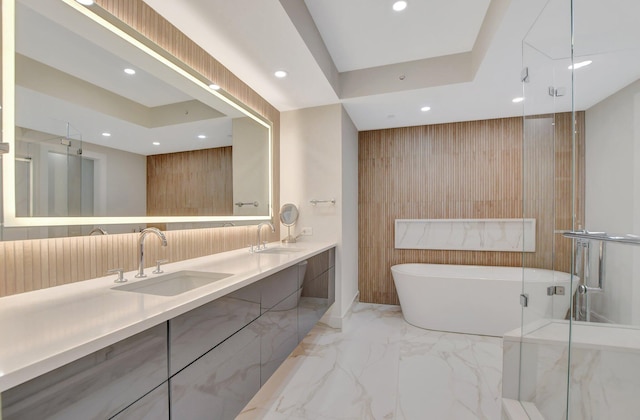 bathroom featuring vanity, a tray ceiling, and plus walk in shower