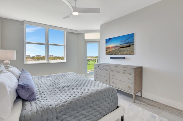 bedroom with ceiling fan and light wood-type flooring