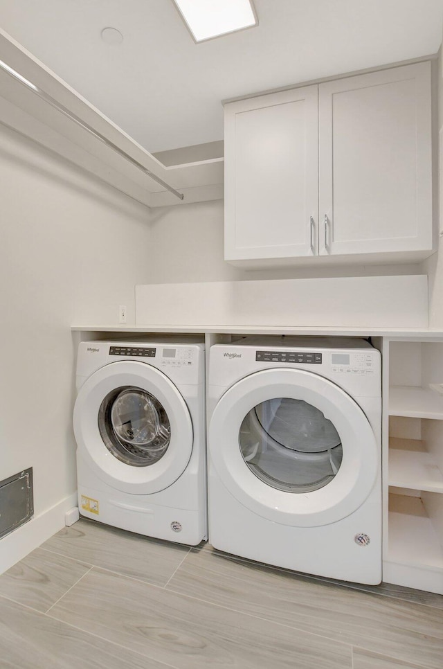 washroom with cabinets and separate washer and dryer