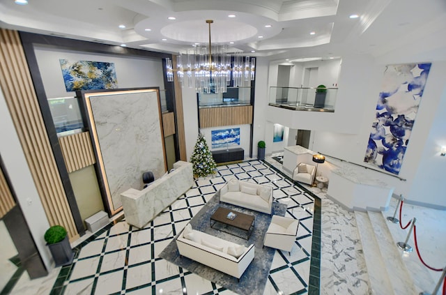 living room featuring ornamental molding and a raised ceiling