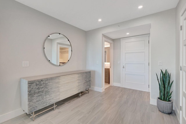 corridor with light hardwood / wood-style flooring