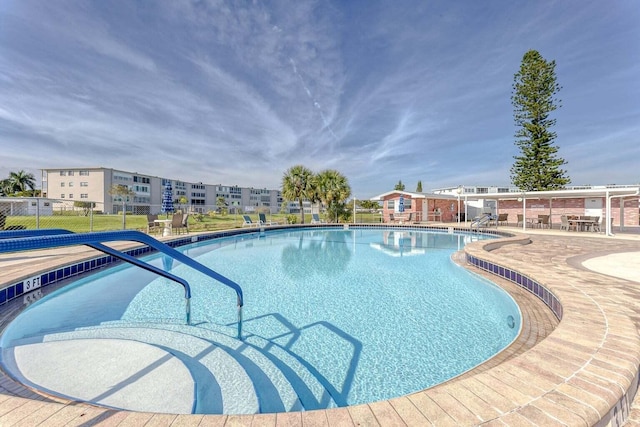 view of swimming pool with a patio