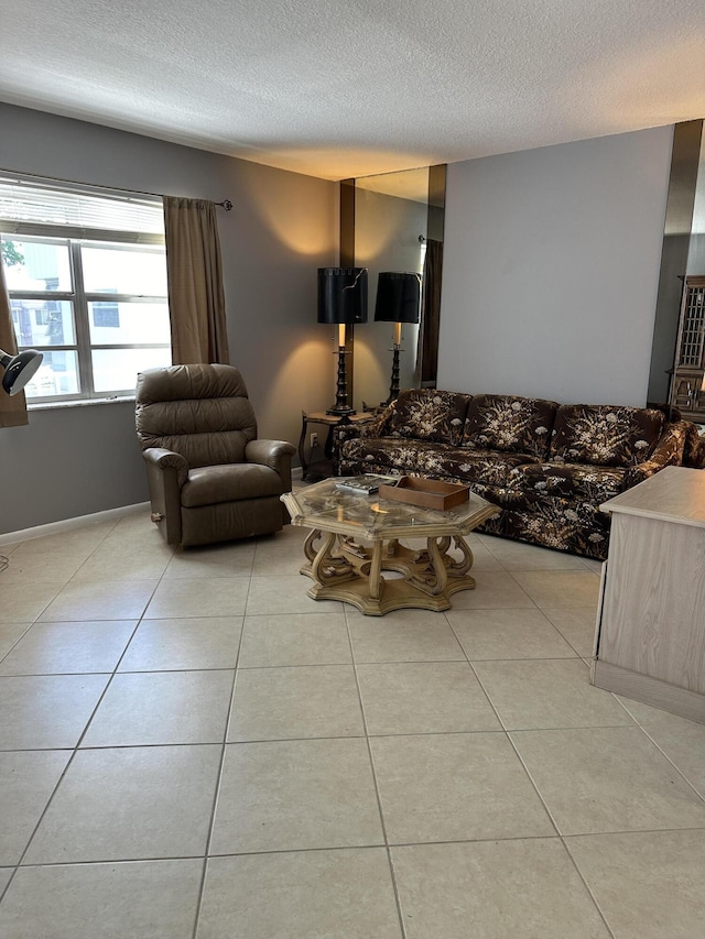 tiled living room featuring a textured ceiling