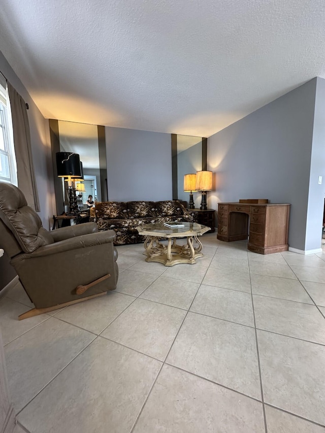 living room featuring a textured ceiling and light tile patterned floors