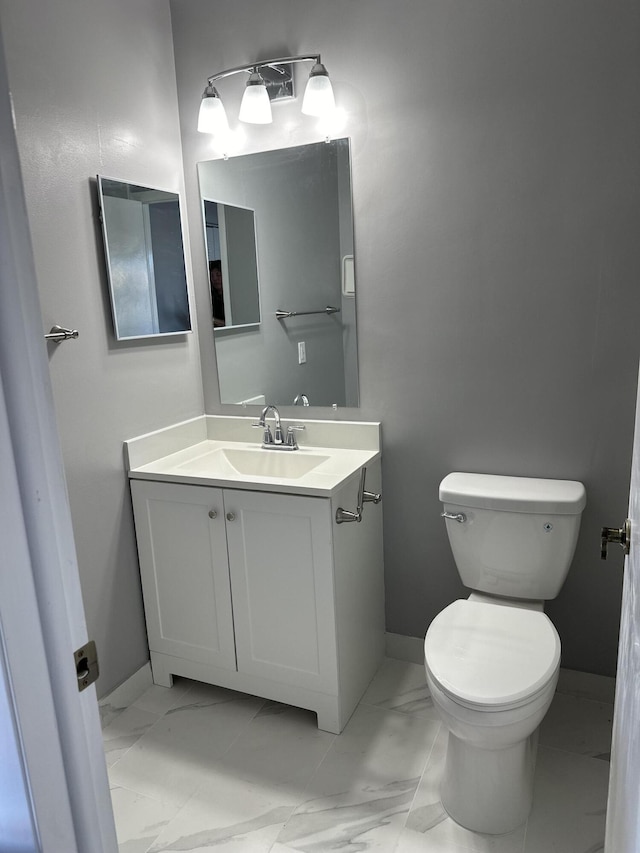 bathroom featuring toilet and vanity