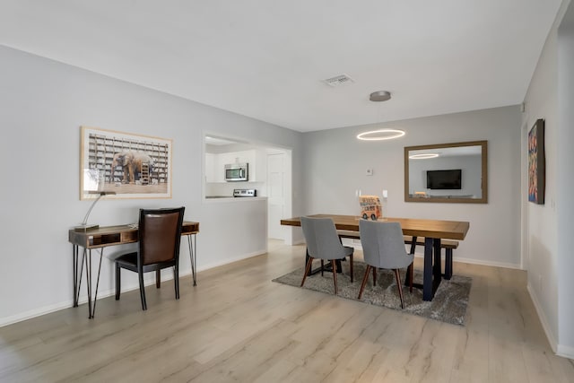 dining room with light wood-type flooring