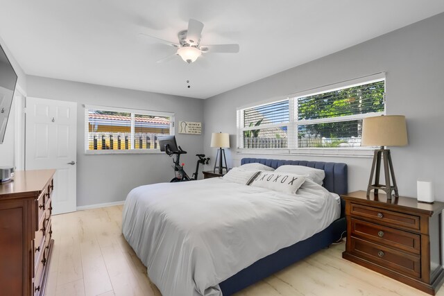 bedroom with ceiling fan and light hardwood / wood-style flooring