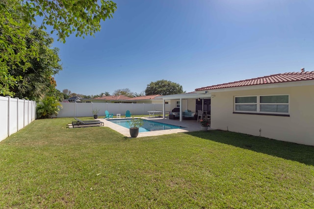 view of yard featuring a patio area and a fenced in pool