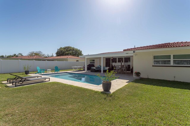 view of pool featuring a patio area, outdoor lounge area, and a lawn