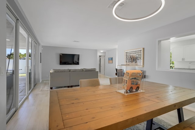 dining space featuring a wealth of natural light and light wood-type flooring