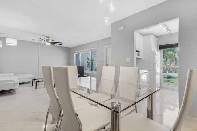 living room featuring ceiling fan, plenty of natural light, and light tile patterned floors