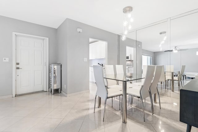 tiled dining room featuring ceiling fan