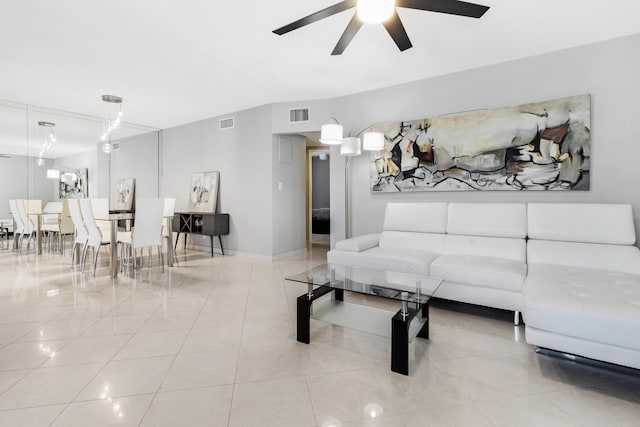 living room featuring light tile patterned floors and ceiling fan