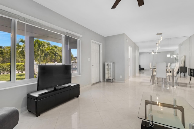 living room featuring light tile patterned floors and ceiling fan