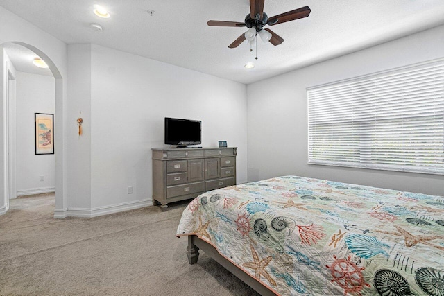 bedroom featuring ceiling fan and light colored carpet