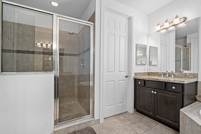 bathroom with independent shower and bath and vanity