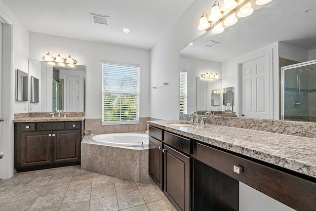 bathroom with plus walk in shower, tile patterned flooring, and vanity