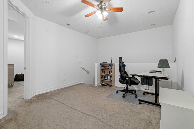 carpeted home office with ceiling fan