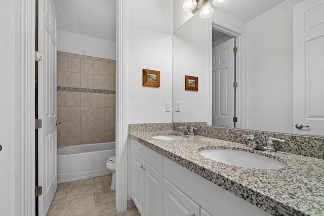 full bathroom featuring toilet, vanity, and tiled shower / bath combo