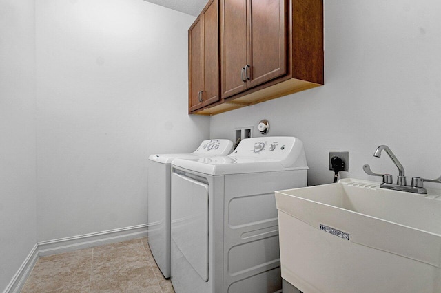 clothes washing area featuring cabinets, a textured ceiling, separate washer and dryer, and sink