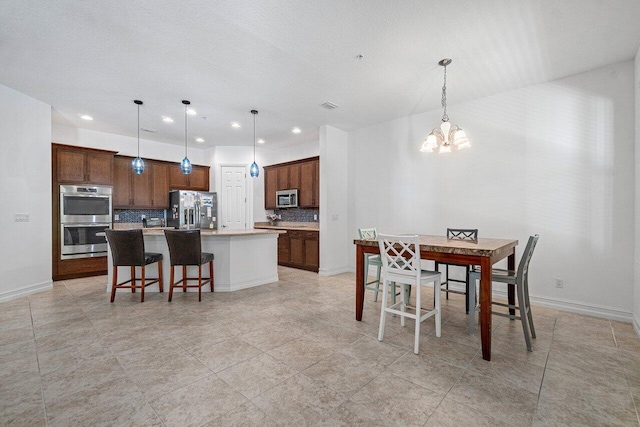 dining area featuring a textured ceiling and an inviting chandelier