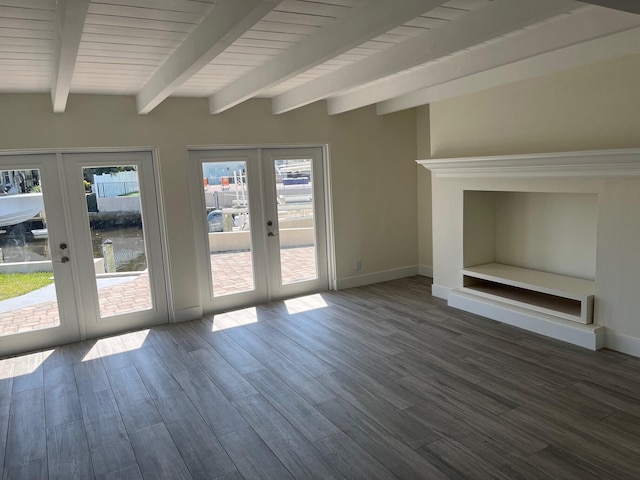 unfurnished living room featuring french doors, baseboards, beam ceiling, and wood finished floors