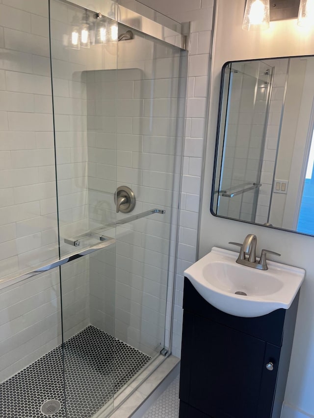 full bath featuring a stall shower and vanity