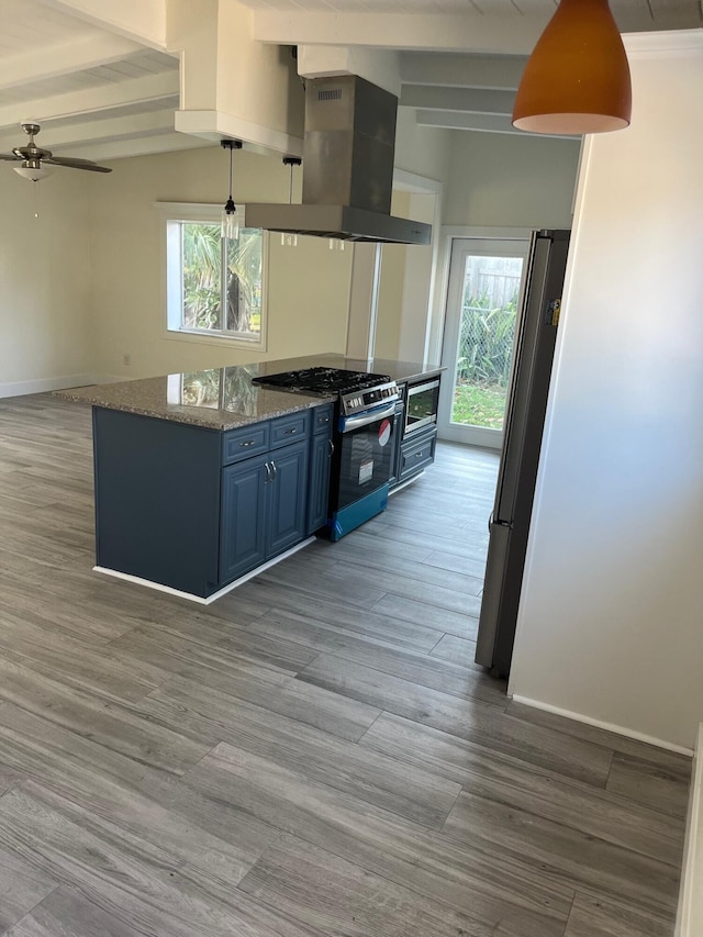 kitchen featuring stainless steel appliances, blue cabinets, plenty of natural light, and island range hood