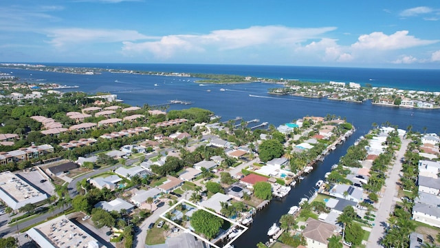 drone / aerial view with a residential view and a water view