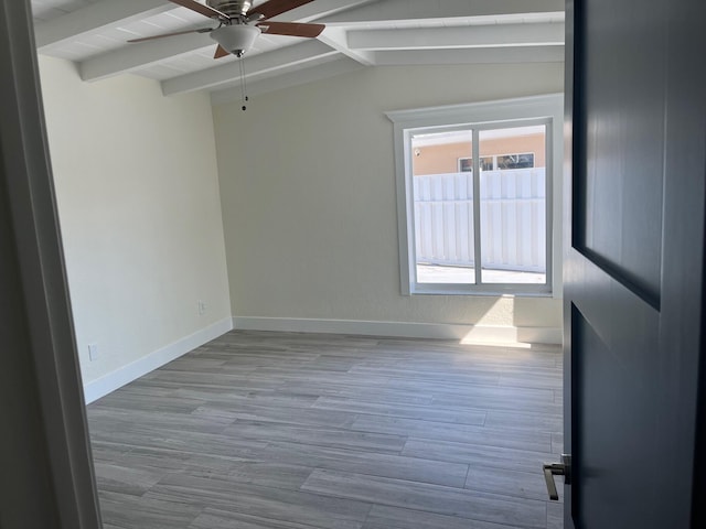 unfurnished room featuring lofted ceiling with beams, ceiling fan, baseboards, and wood finished floors