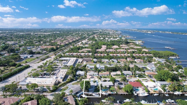 birds eye view of property with a water view and a residential view